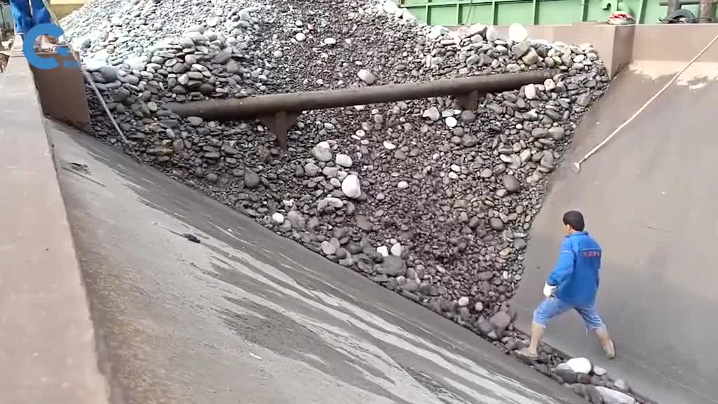 不可思议的自卸船由工人控制卸料速度