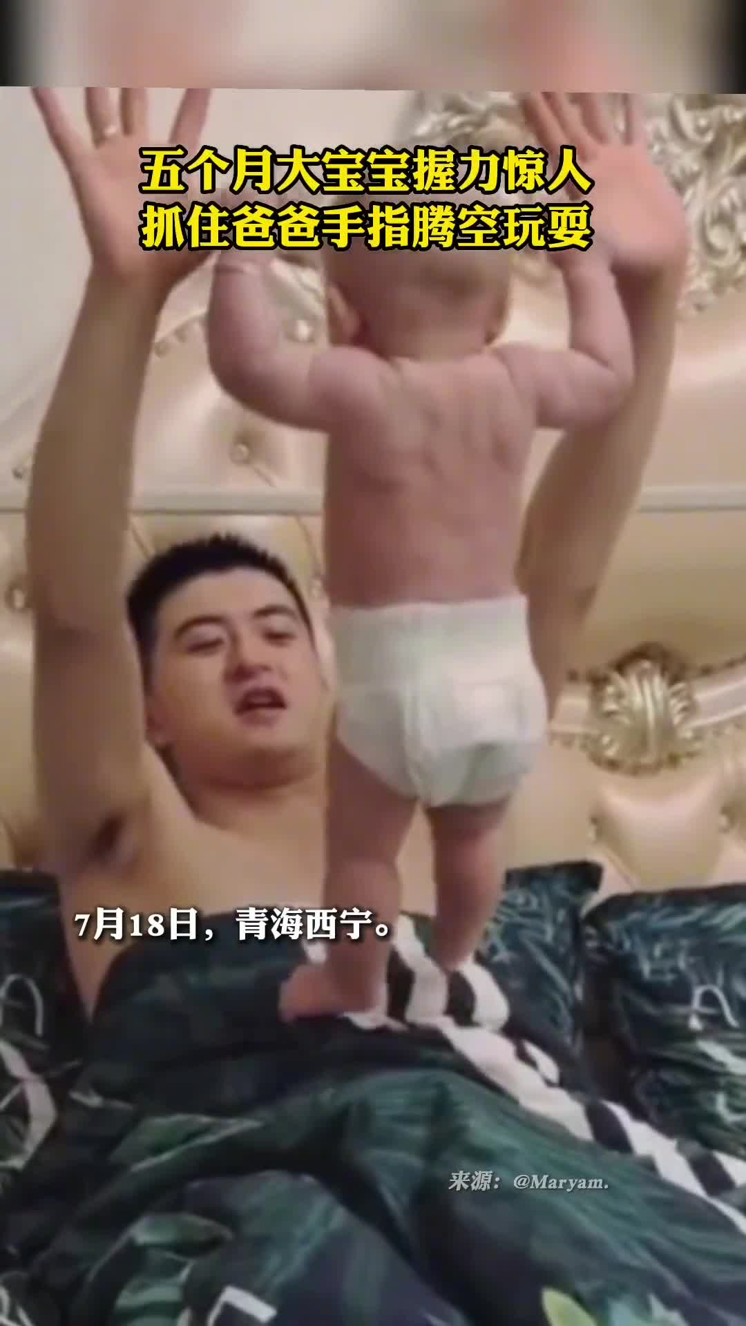 我看见了他的背肌五个月大的宝宝抓住爸爸手指腾空玩耍