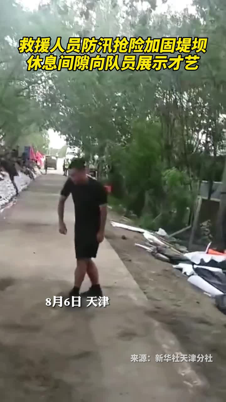救援人员防汛抢险加固堤坝休息间隙向队员展示才艺
