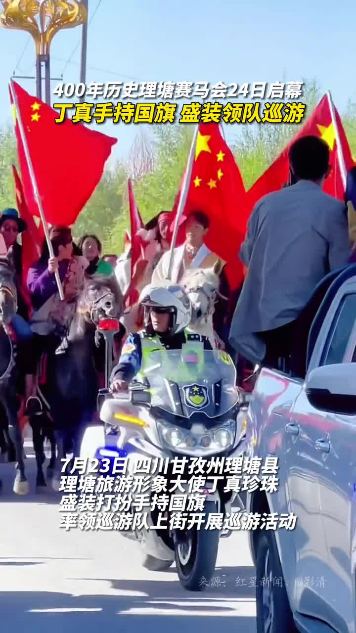 理塘旅游形象大使丁真珍珠盛装打扮手持国旗率领巡游队上街开展巡游活动