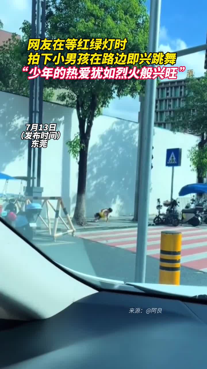 网友在等红绿灯时拍下小男孩在路边即兴跳舞