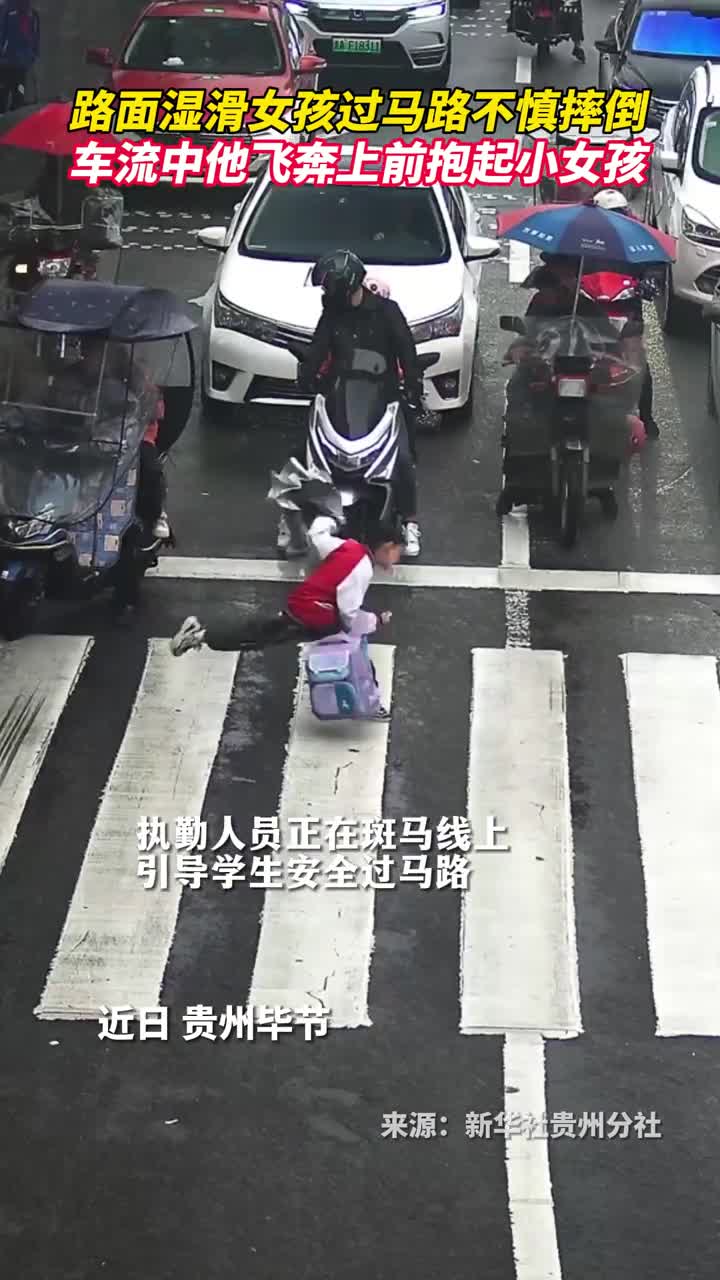 路面湿滑女孩过马路不慎摔倒车流中他飞奔上前抱起小女孩